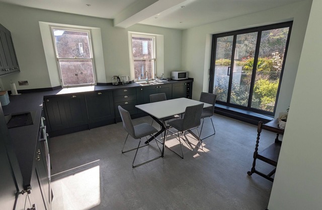 Central holiday home with pretty, sunny garden, moments from the station, golf course and beach.