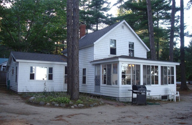 Classic pine paneled Maine cottage with large sandy beach on Sebago Lake.