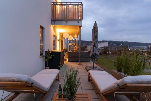Earthy Ground Floor Home with Patio Sunbeds Greenery