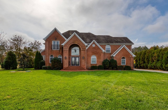 Expansive estate with pool, basketball court, & wet bar