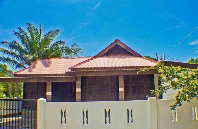 Holiday house in traditional wooden construction with massive cultivation