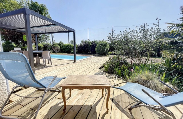 House with swimming pool in wooded grounds