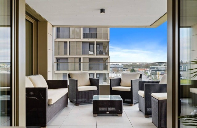 Lux City Escape: 2BR Apt with Balcony & Workspace