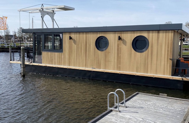 Luxury Houseboat with swim platform in colorful harbor
