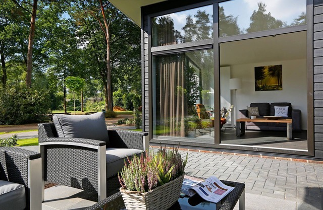 Modern chalet with a smart TV near forest