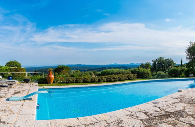 Modern villa in park swimming pool and floodlit tennis court