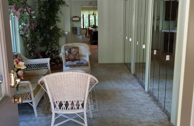 Nestled near woods and creek, this large home is near state parks and colleges.