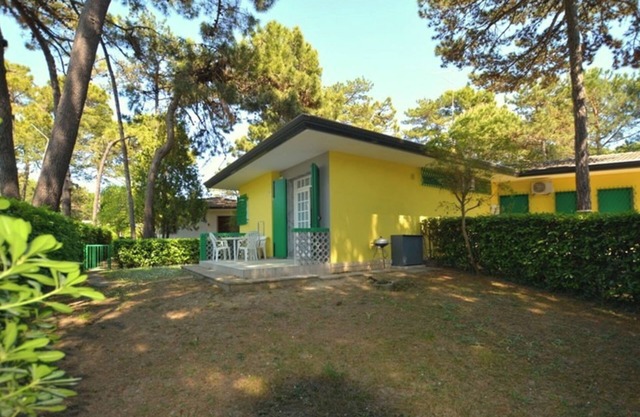 Semi detached villa with private fenced garden in Lignano Pineta