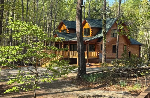 Stunning SML lakefront cabin: luxurious finishes, spacious rooms, wraparound deck, easy dock access. Family-friendly with toys, media room, serene views!