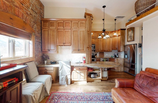 Stylish, downtown condo w/loft, kitchen, & fireplace plus shared patio & grill