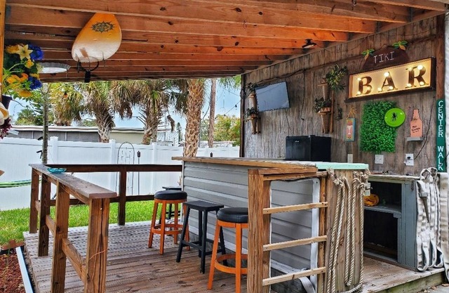 The Tiki Hut Oasis, a tropical Beach home with firepit, patio, and more!