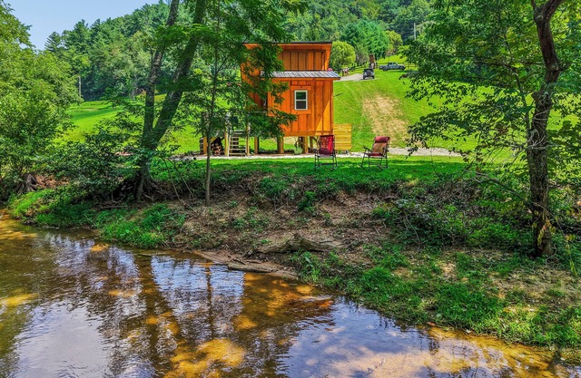 Tiny cabin sits by a bubbling, stocked creek. Pet friendly, for a fee, hot tub