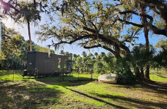 Tiny home next to private pond on 1.75 acre fenced in homestead property.