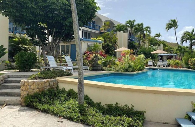 Tropical one bedroom condo steps from pool.