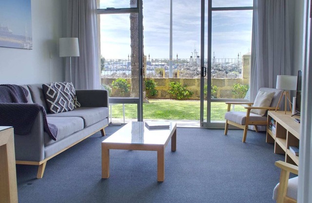 Wake up to sweeping harbour views in this modern, split-level apartment located between Fishing Boat Harbour and Challenger Harbour. Whether you're a couple, a family, or here on business, this peaceful retreat offers the best of coastal charm and ci