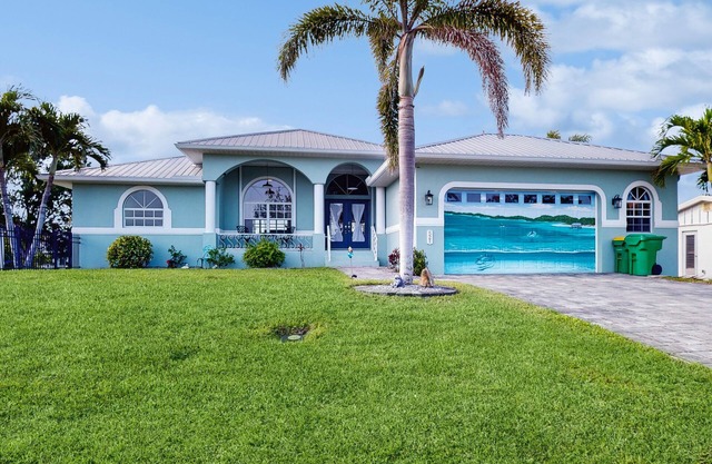 Waterfront home with saltwater pool, firepit, boat access, and dock