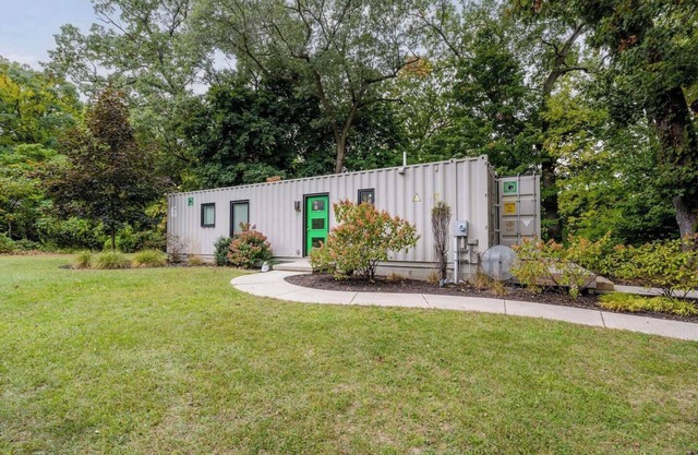 Welcome to a one-of-a-kind getaway in this modern and thoughtfully designed container home. Nestled in a quiet, wooded lot within Benton Harbor, the home offers a peaceful retreat just minutes from the beaches of Lake Michigan and charming shops