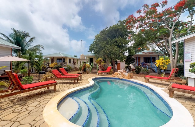 Wood cabana with a porch, pool view, WiFi, and a shared common area with grills