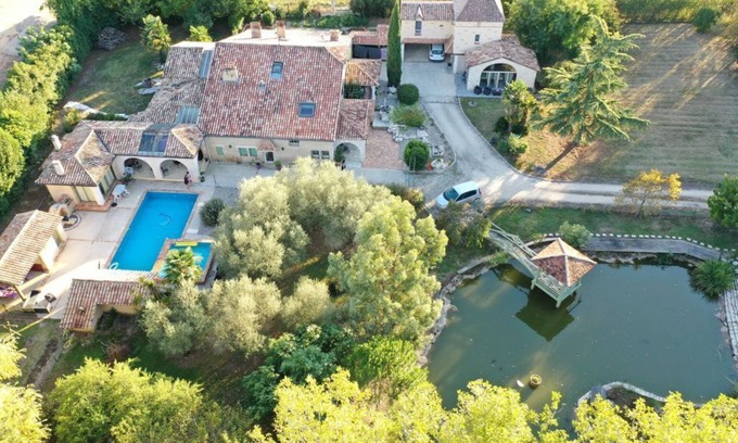 Montpouillan House | A bucolic stone estate with a cascading pool.