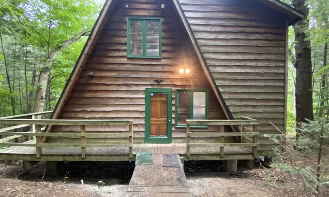 Allegan House | A-frame cabin nestled in forest, stunning lake view, perfect serenity.