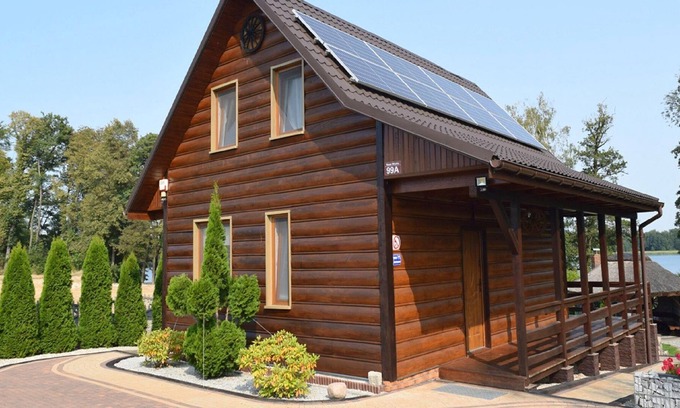 Lubna House | A luxury home on the shore of the lake. Living room with fireplace, 2 bedrooms.