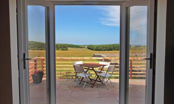 Wandylaw Cottage | A stylish cottage with rural views towards the coastline from the patio.