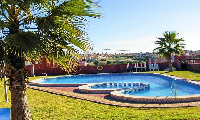 Orihuela Costa Apartment | Apartment with Large Roof Solarium, Pool, Garden, Barbecue, A/C & Wi-Fi