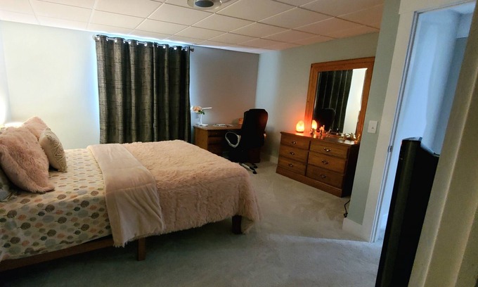 Williston North Condo | Basement Space with bedroom, living room, movie theatre and gym.
