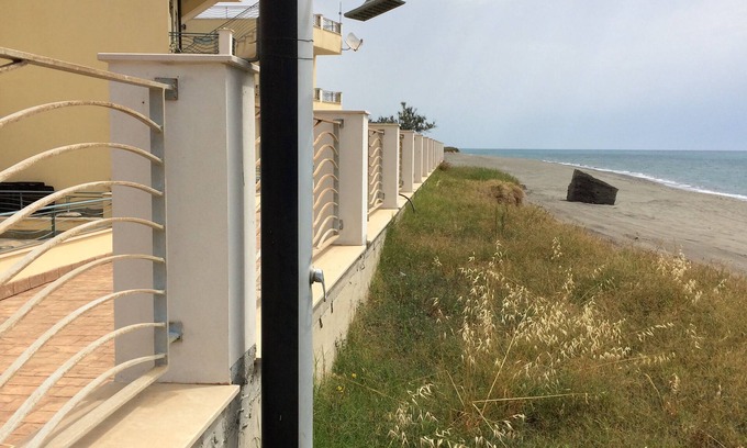 Brancaleone Apartment | Beachfront apartment in prime position with rooftop terrace, balcony and patio.