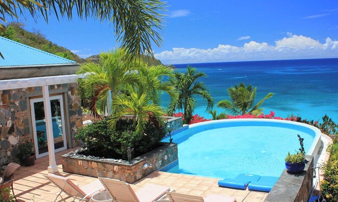 Rendezvous & Ditleff Villa | Carnival Beach House Awaits: Relax in Style with Beachfront Views, A/C, and a Private Pool!