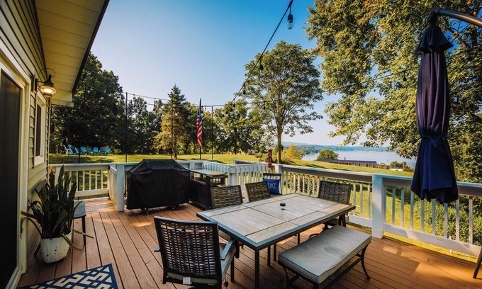 New River House | Charming lakeside retreat with serene views, cozy interiors, spacious deck, and lush outdoor spaces.