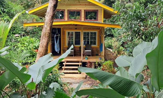 Carenero Island Cottage | Charming Tiny House, 1 minute walk to surf and beaches, peaceful.