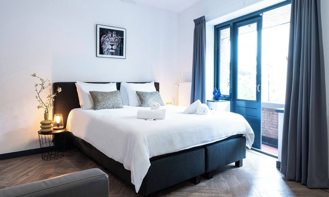 Tilburg Apartment | Contemporary studio featuring a private kitchen, bathroom, and two balconies
