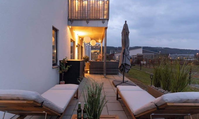Bastad Condo | Earthy Ground Floor Home Patio Sunbeds Greenery