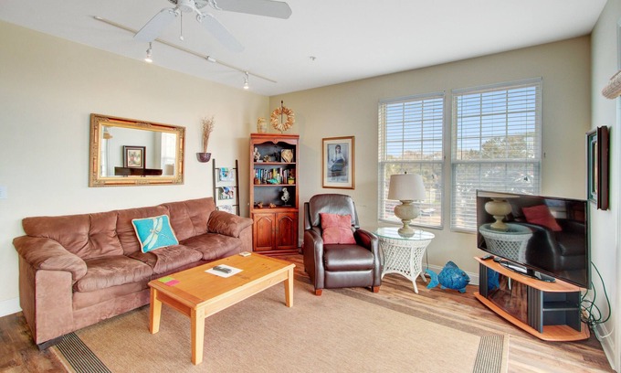 Folly Beach Condo | First-floor villa w/partial ocean views, covered porch -one block from the beach