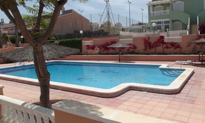 Los Arenales del Sol Apartment | Ground floor corner apartment with WIFI, spacious sunbathing area and pool views
