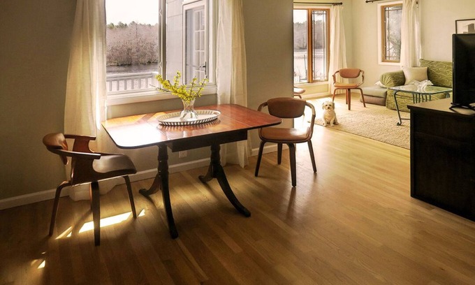 Riverhead House | Light rippling on river, private dock, nature preserve beyond