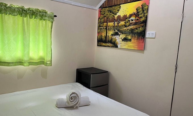 Bacnotan Cottage | Local style cottage in a garden setting - cosy comfort with A/C