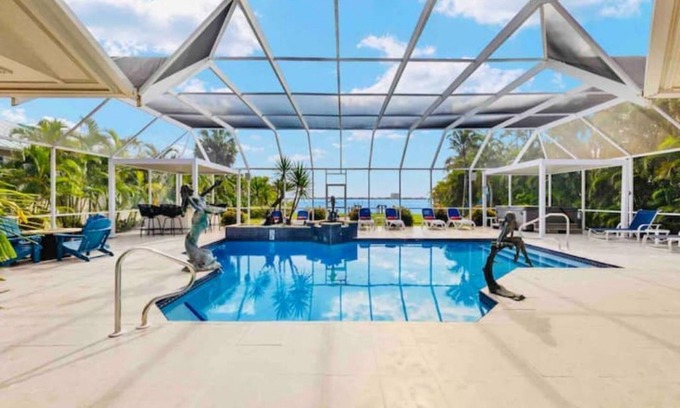 Yacht Club House | Lux Riverfront Retreat~Pool~Spa~Outdoor bar~Tropical Yard~Direct Gulf Access