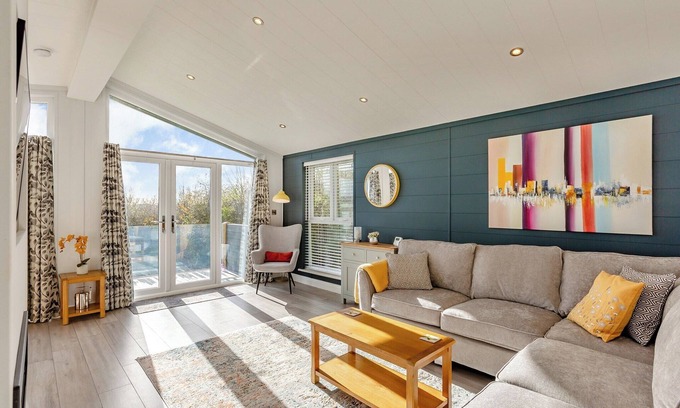 Middlezoy Ski Chalet | Luxurious lodge with vaulted ceilings and a welcoming feature fireplace.