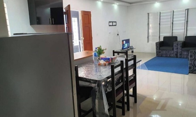 Suva Apartment | Master Bedroom with shared kitchen and living room