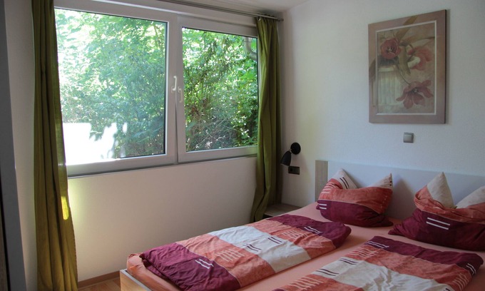 Friedrichroda House | Modernly furnished bungalow with fireplace, surrounded by greenery.