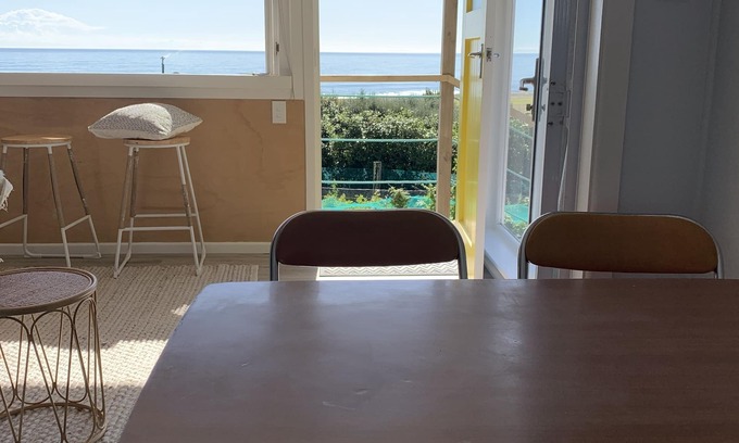 Cape Palliser House | Ocean views of the Kaikoura's and surf break. Private beach hut.
