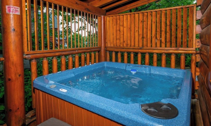 Sevierville Cabin | Rockin' in the Smokies | Enjoy grilling out, cozying up in the hot tub, or playing arcade games!