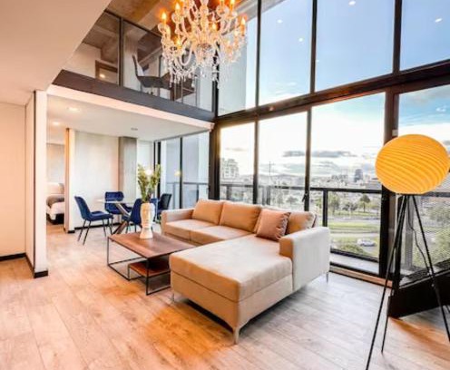 Barrios Unidos Apartment | Skyline Suites - Elegant Living with Coworking & Scenic Views