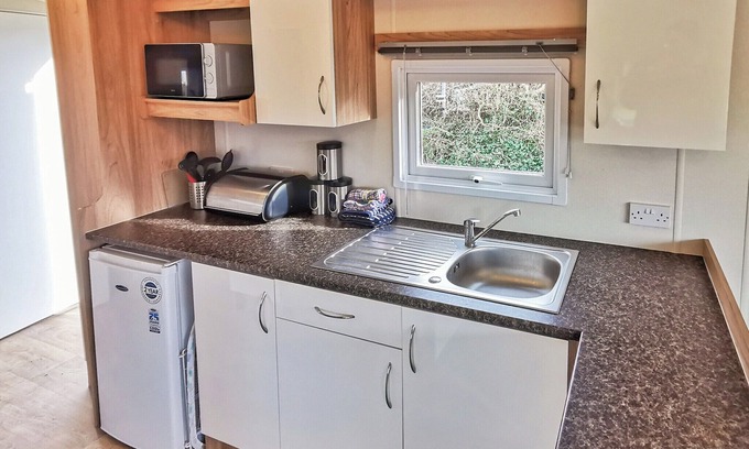 Llanllwchaiarn House | Spacious and well presented, 12-ft wide caravan with one double and one twin bedroom.