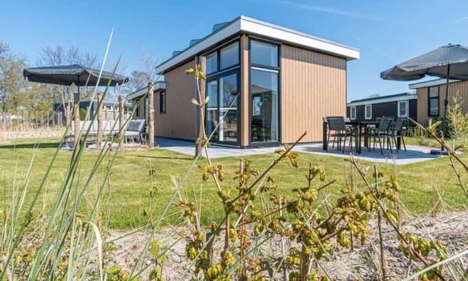 Burgh-Haamstede House | Spacious living room with a stylish interior, charming accents and a beautiful view of the expansive
