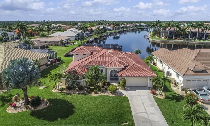 Burnt Store Isles House | Spacious, waterfront home with dock, heated pool, and lanai