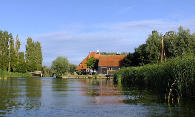 Idsegahuizum House | Special holiday home on the water with its own jetty and boat