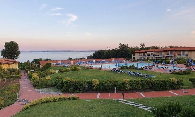 Manerba del Garda Apartment | Stunning three-room lake view in a residence with three swimming pools and 36,000 m2 of greenery